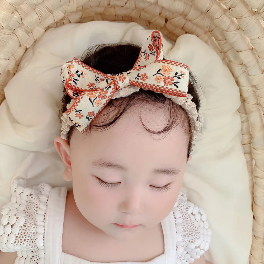 Повязка на голову детская нейлоновая с большим бантом и цветочной вышивкой