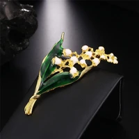 trendy lily valley gold color brooch pin jewelry white floral leaf luxe brooch