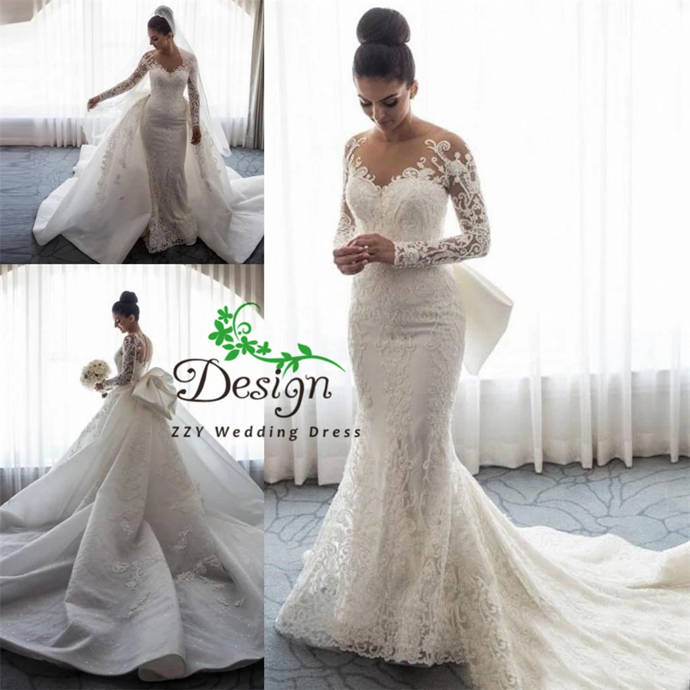 

2023 Luxury Mermaid Wedding Dresses Boat Neck Long Sleeves Illusion Full Lace Appliqued Bow Overskirts Button Back Bridal Dress