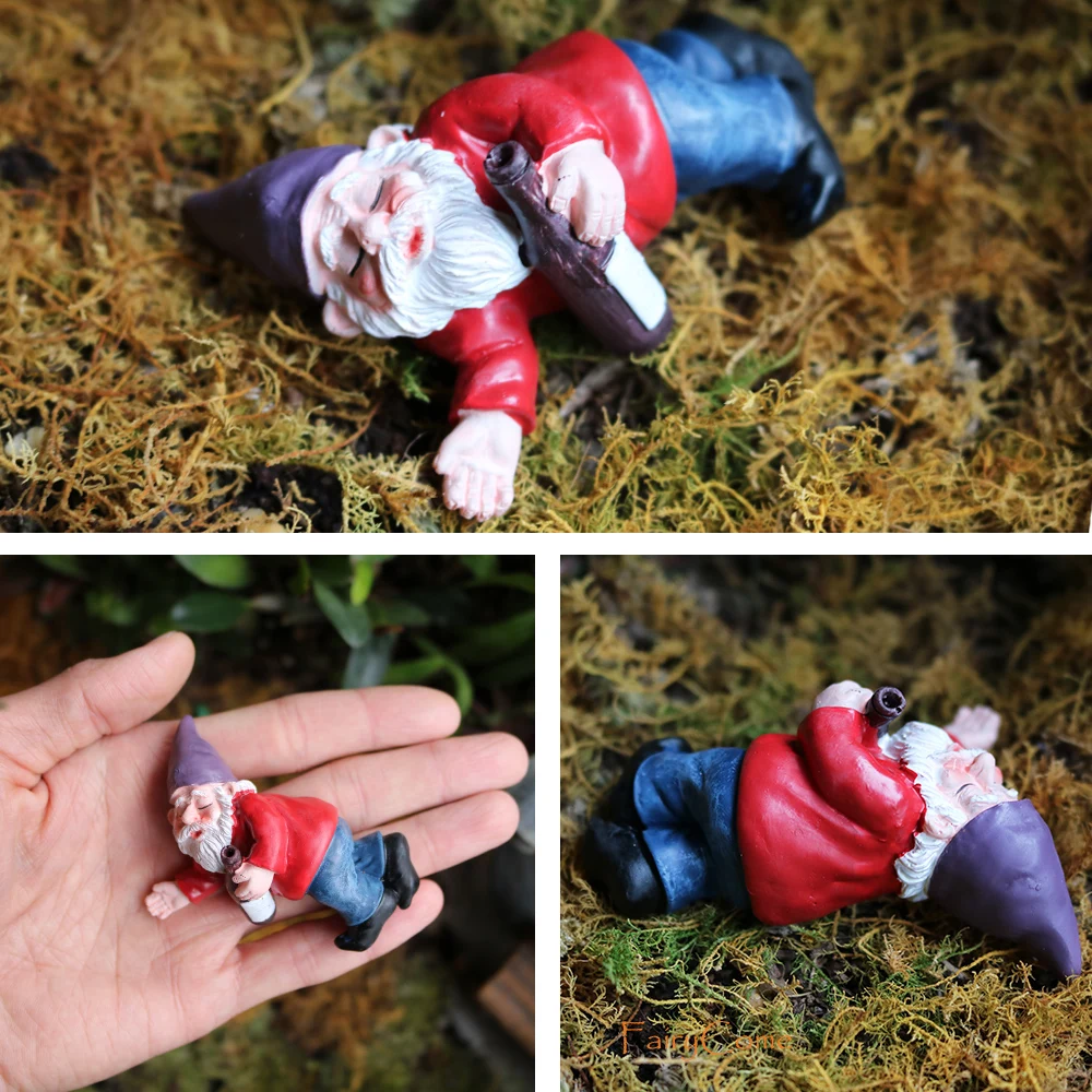 Reclining red-hatted gnome on moss with a gnome held in a palm for scale