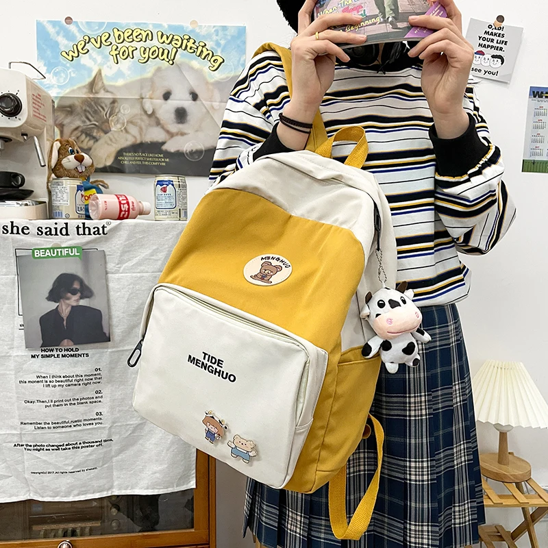 

Student Bags Waterproof School Bags Teenage Girls College Backpack New Cute Cow Pendant Women Backpack Small Fresh Cartoon Badge