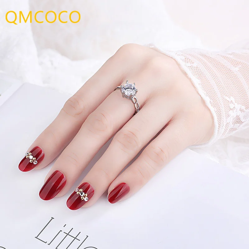

QMCOCO Silver Color 2021 Summer New Hot Sell Simple Elegance Rings For Women Six Claws Zircon Open Rings Birthday Presents