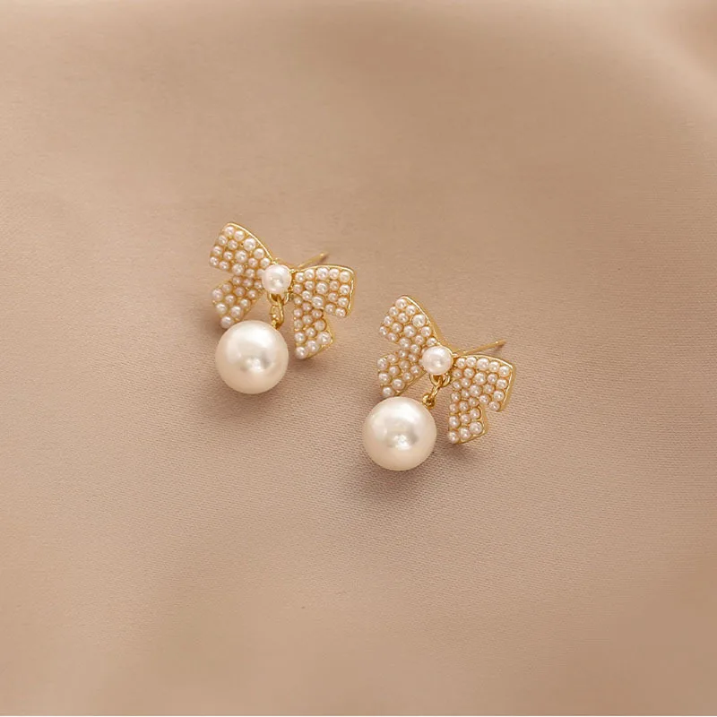 

KOUDOUN Women Sweet Pearl Bow Gold Stud Earrings for 2021 Fashion Korean Jewelry Goth Girls Unusual Earrings Women Accessories