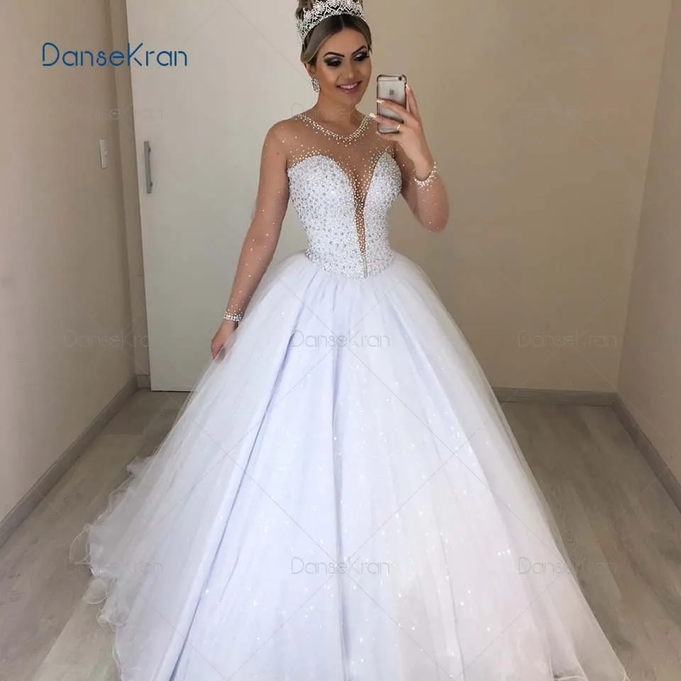 

Illusion Neck Shiny Wedding Dresses With Rhinestone Long Sleeves Ball Gown Bride Dress Zipper Up Back Sparkle Tulle Bridal Gown