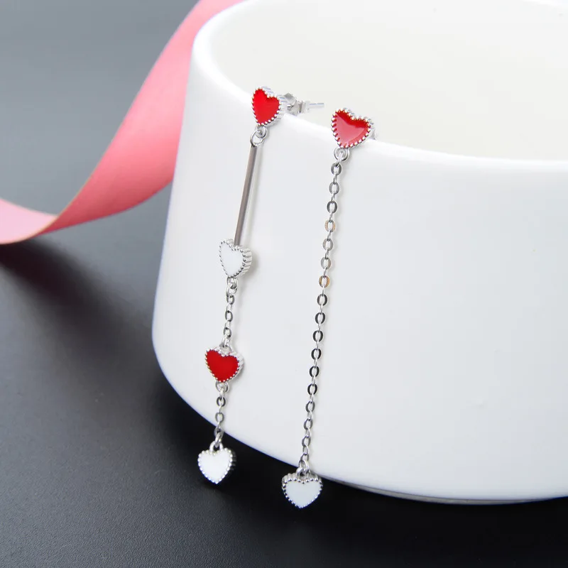 

Korean fashion temperament asymmetrical love earrings S925 pure silver drop oil long nail jewelry