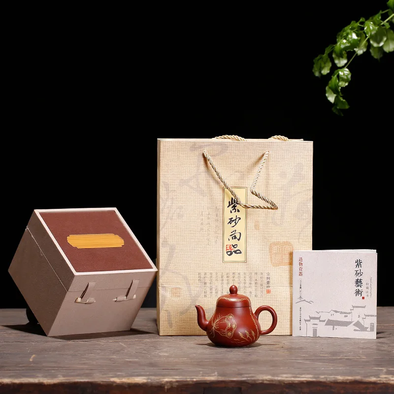 

Raw ore Dahongpao pear shaped teapot real gold depicting hand made siting small kungfu tea ceremony