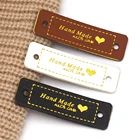 50 шт., кожаные этикетки в виде сердца, 56 х15 мм