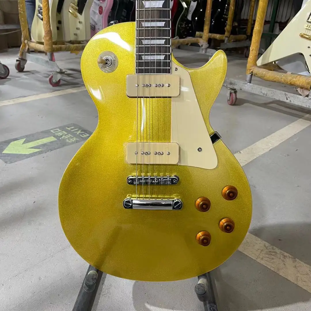 Стандартная электрогитара металлического золотого цвета с корпусом из махагони и грифом из палисандра с звукоснимателями P90. Высокое качество. Бесплатная доставка.