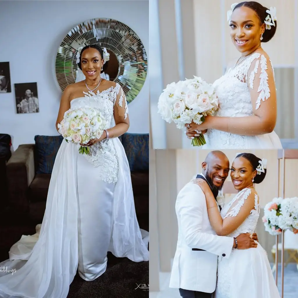 

Свадебные платья с юбкой годе на одно плечо в африканском стиле со съемным шлейфом, с длинными рукавами и аппликацией из кружева