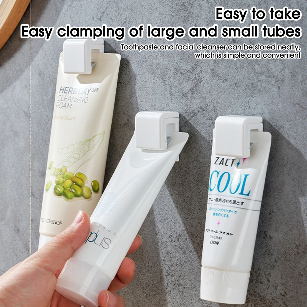 

Self Adhesive Toothpaste Rack Hanging Holder Facial Cleanser Clip Wall Mount Stand Organizer Bathroom Accessories Home Storage
