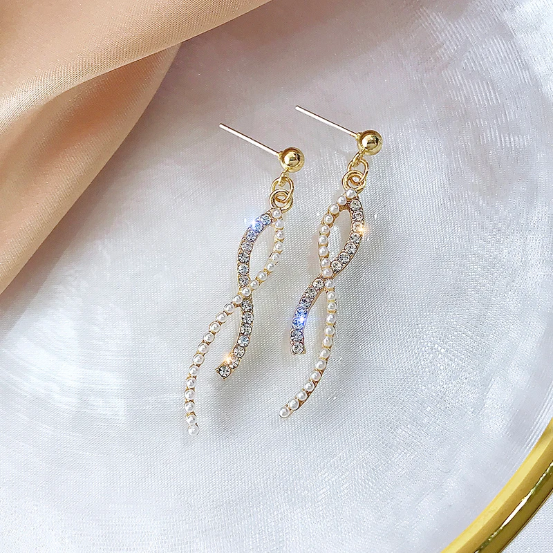 

Niche high-end diamond-studded pearl cross tassel earrings female temperament long style cold wind ear jewelry