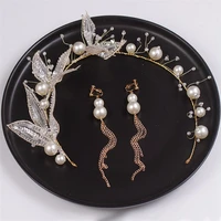 the brides handmade hair accessorized with shiny light gld leaf hairpin earrings and wedding photography accessories