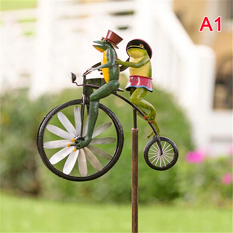 

Vintage Bicycle Wind Spinner Metal Stake Frog Riding Motorcycle Windmill Decor