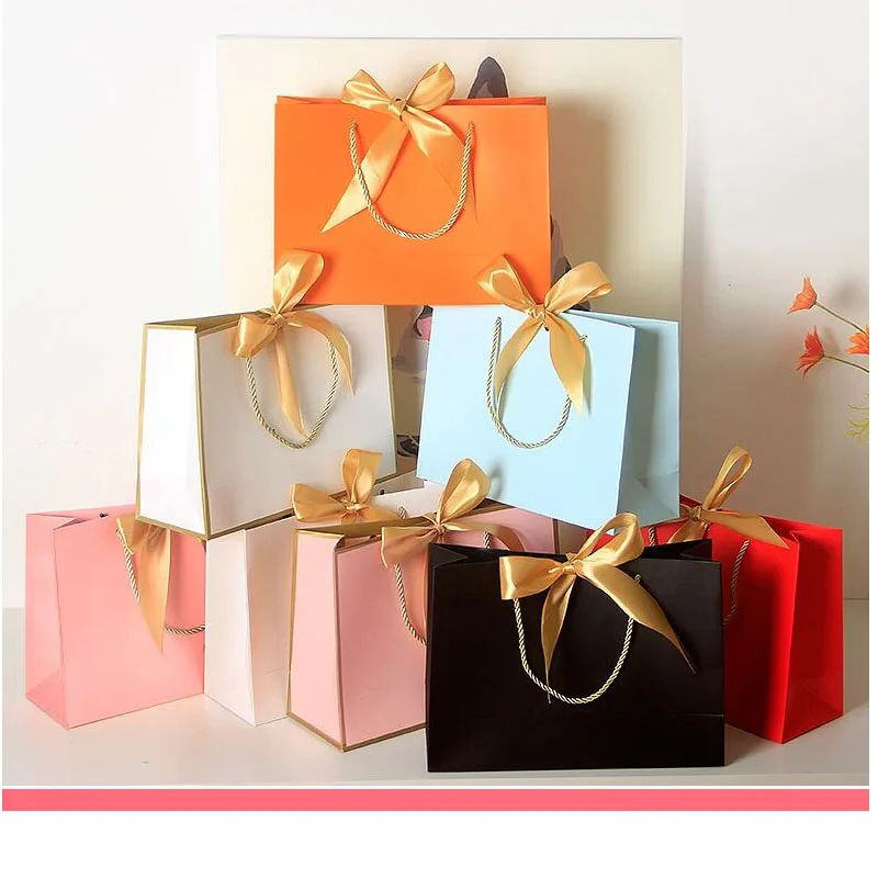 

Wholesale Paper Gift Bags with Ribbon Bow Recycled Wedding Shopping Bags with Handles Clothing Cosmetic Jewelry Packaging Bags