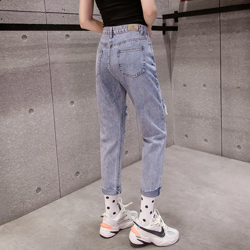 

high-waist jeans Featuring five-pocket design ripped detailing on the front and zip fly and metal top button fastenins