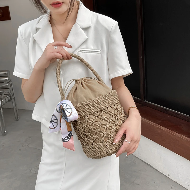 

The new barrel-shaped woven handbag pattern hollow beach bag Sen barrel silk scarf portable straw woven bag popular fashion