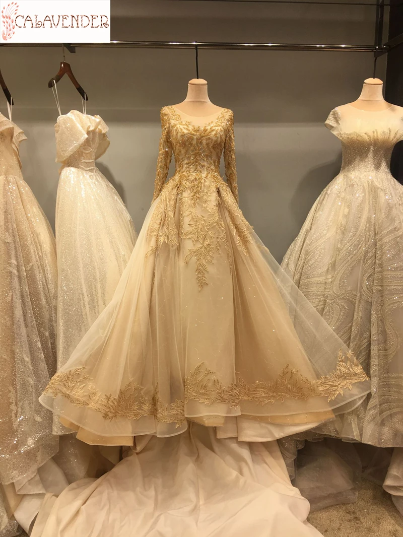 Lace Gold Wedding Dresses Ball Gown Appliques Crystals Beaded Wedding Gown with Chapel Train Long Sleeve Bridal Dresses vestidos