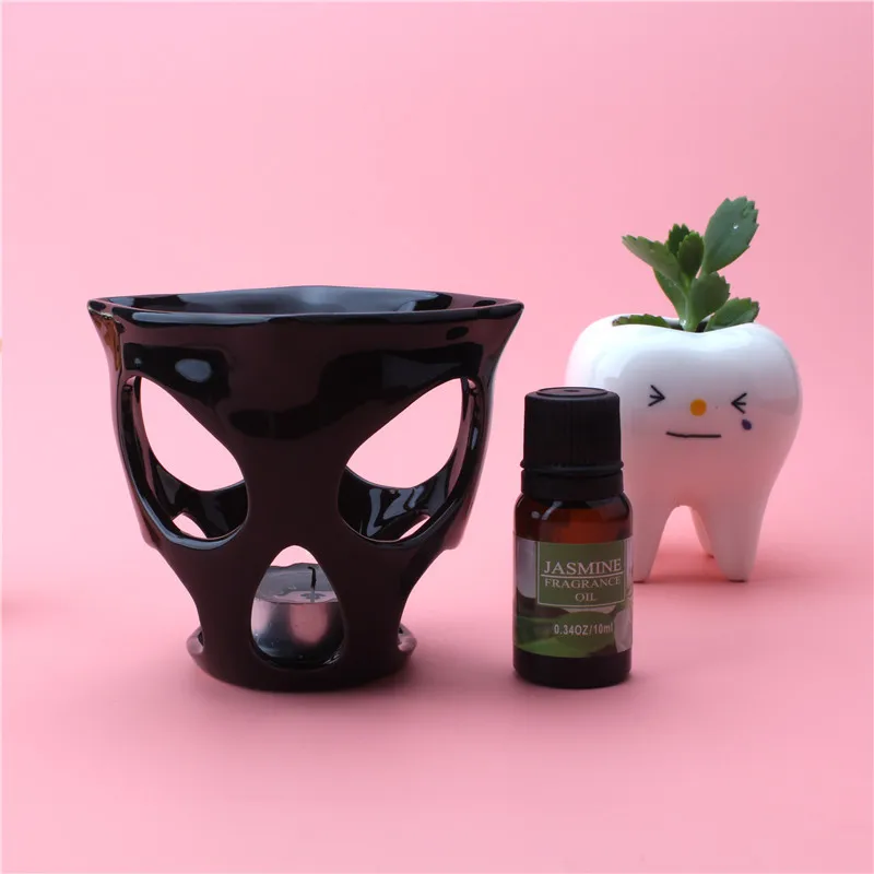 

New Hollow Black Skull Essential Oil Heater Ceramic Tea Wax Aromatherapy Stove Candle Holder Base Home Essential Oil Lamp