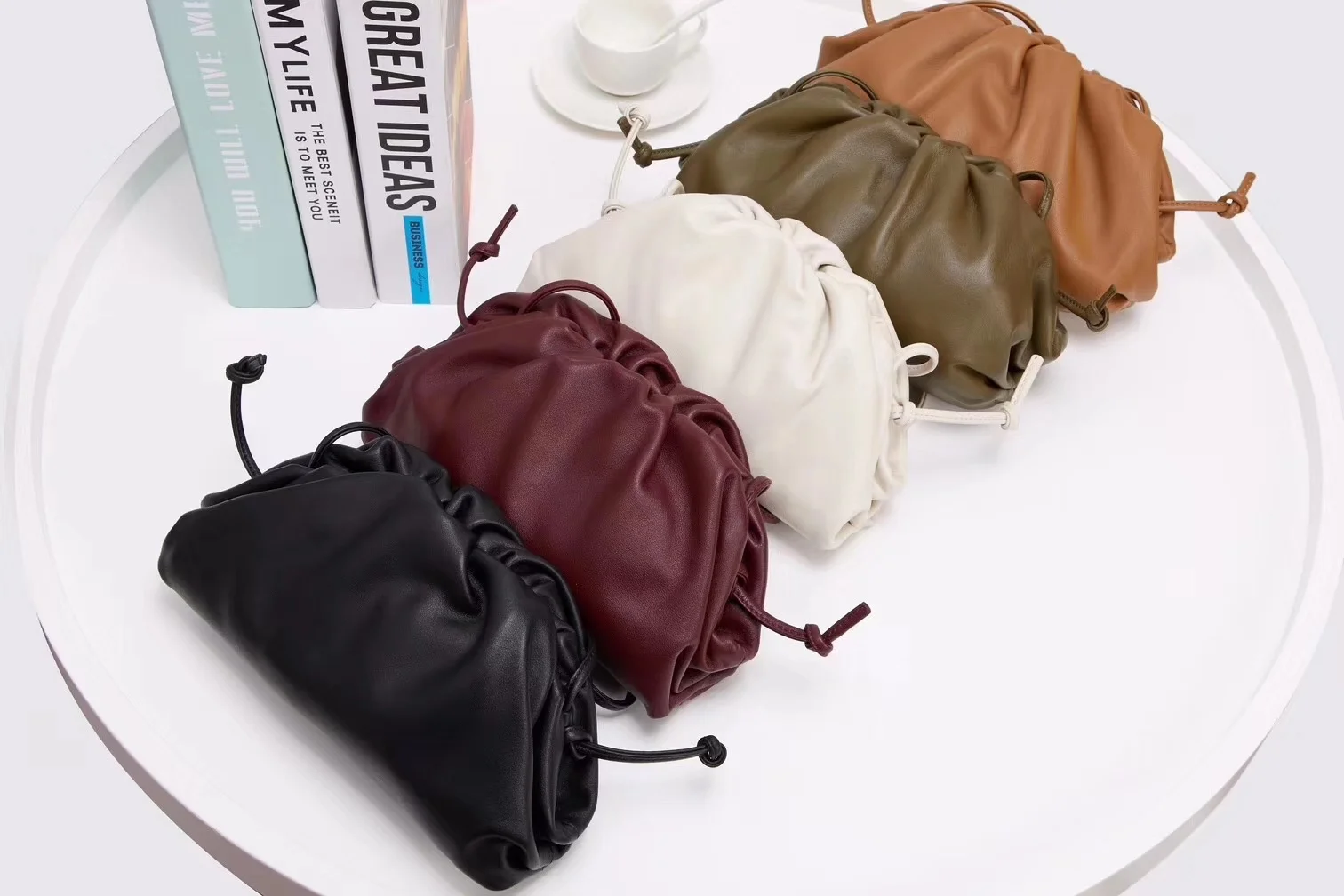 

Fashionable pleated cloud bag female inclined across one shoulder hand with port