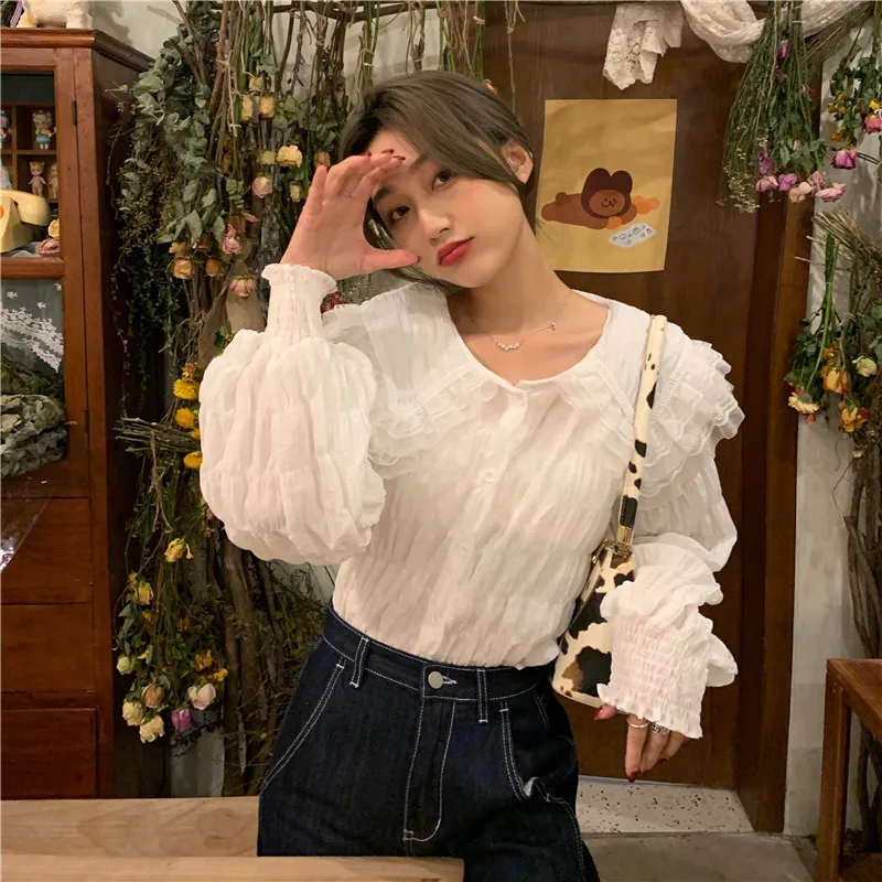 

RUGOD2021 early spring Korean peter pan collar simple solid shirt pleated tassel shirt elegant fashion termperament solid shirt