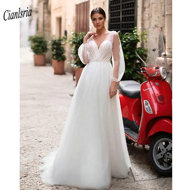 

Великолепное длинное богемное свадебное платье с v-образным вырезом и бисером; свадебное платье с длинными рукавами и перекрещивающимся кр...