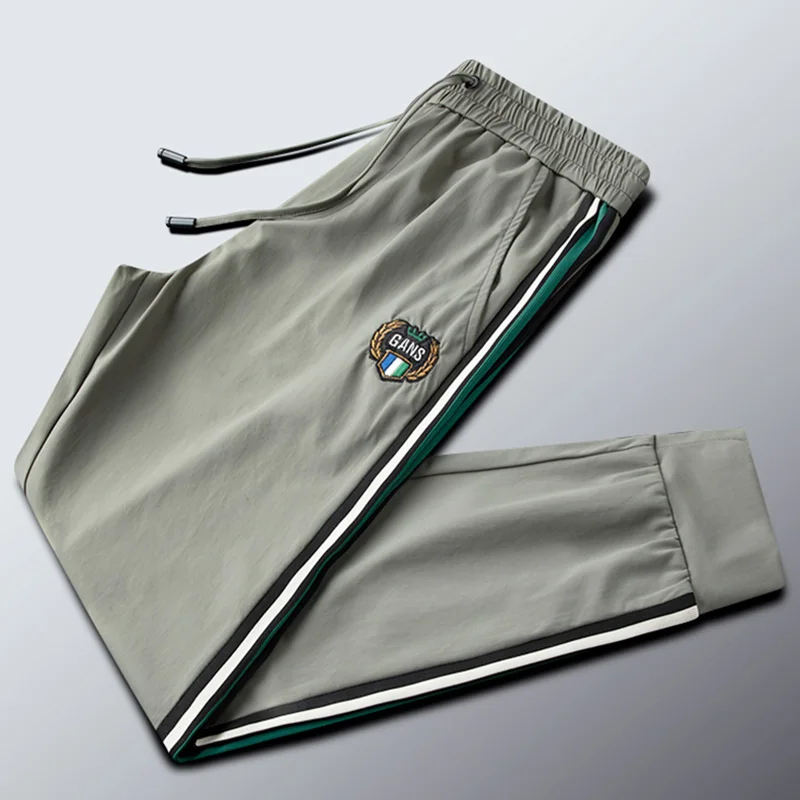 Gray-green side stripes webbing casual sports pants men's back pocket zipper ice silky men's trousers