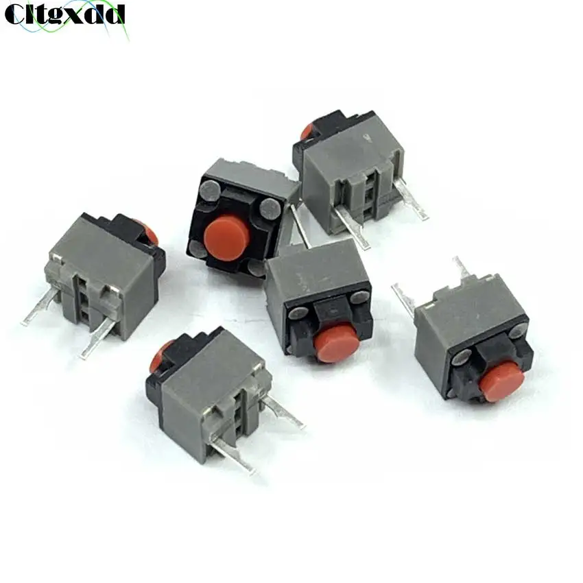 Una colección de componentes electrónicos, específicamente lo que parecen ser conectores o terminales. Estos conectores se utilizan normalmente para asegurar cables a una placa de circuito u otro dispositivo electrónico. Tienen un cuerpo rectangular con un botón rojo o naranja en la parte superior, que a menudo se usa para asegurar el cable en su lugar.