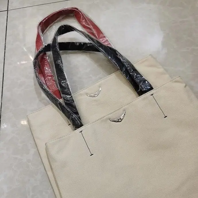 

Beige Canvas and Cowhide Embroidered Letter Wings and Rivet Decoration Shoulder Bag