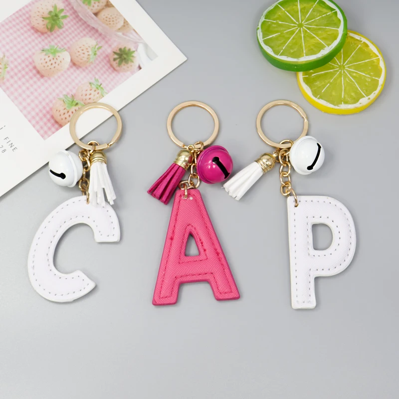 

English alphabet keychain creative gift PU leather alloy bell flannel tassel accessories bag key chain pendant