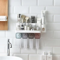 bathroom magnetic cup storage rack organizer automatic toothpaste dispenser with cups toiletries wall mount toothbrush holder