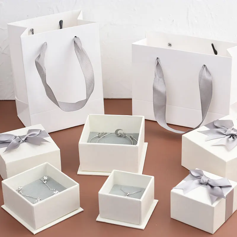 

10Pcs New Creative White Kraft Paper Jewelry Packaging Boxes With Grew Bow Grey Sponge Inside Gift Package For Ring Earrings