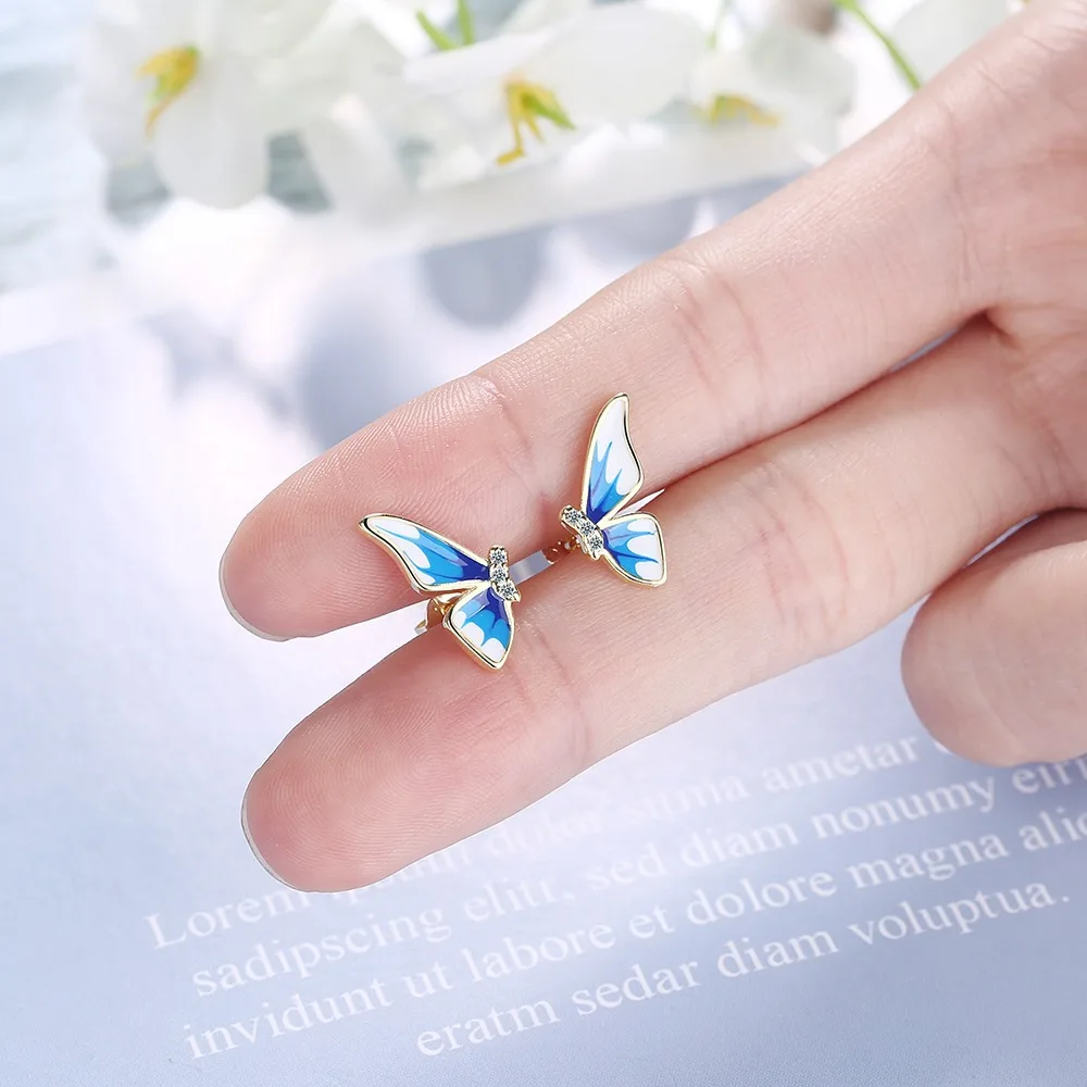 

Cute Female Blue Enamel Butterfly Earrings Dainty Gold Color Stud Earrings For Women Trendy Bride White Zircon Wedding Earrings