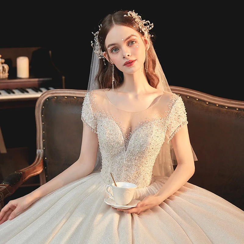 

Luxury Princess Wedding Dress Long Sleeves O-Neck Beading Sequins Shiny Champagne Chapel Train Saudi Sexy Illusion Bridal Gowns