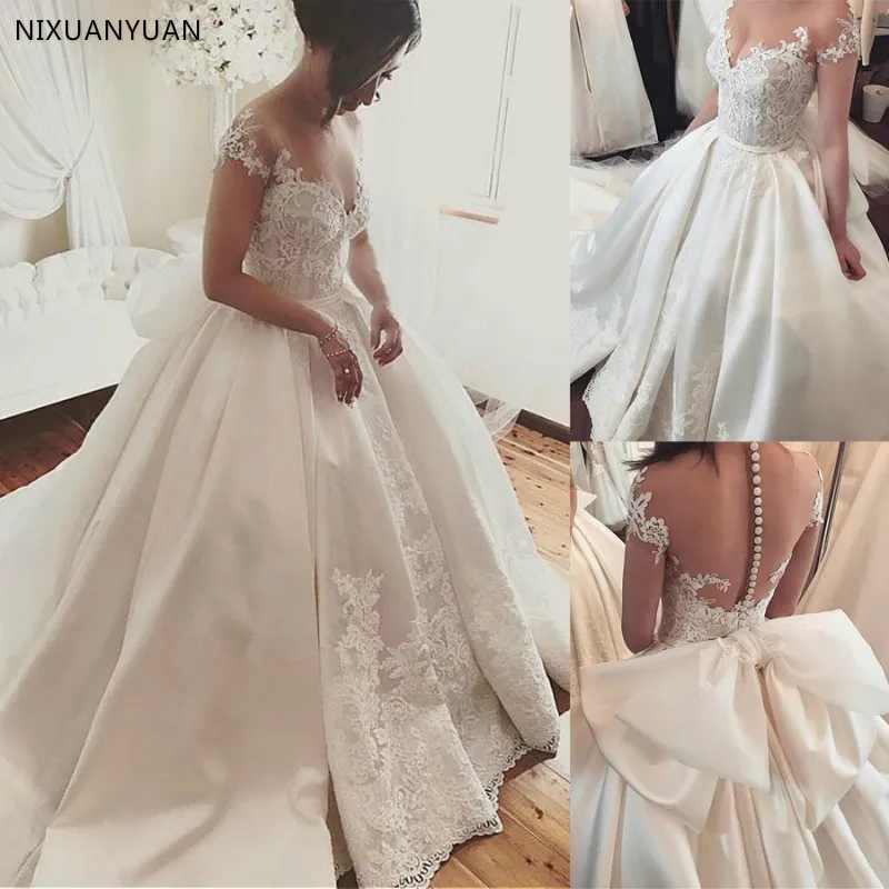 

Fascinating Satin Sheer Jewel Neckline Ball Gown Wedding Dress with Lace Appliques & Belt with Huge Bowknot Bridal Gowns