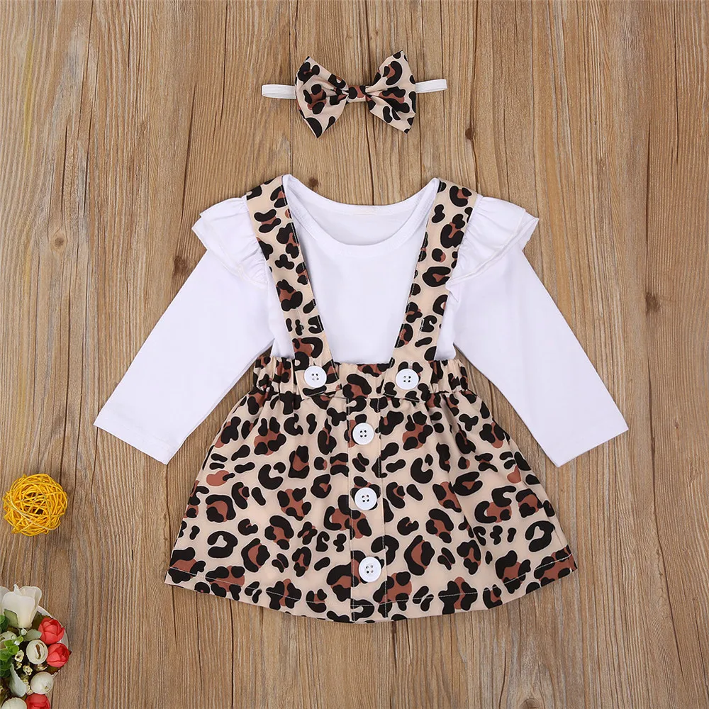 

WenaZao 3 PCS Baby Girls Dress Set Lace Long Sleeve Solid Color Top Leopard Print Suspenders Button Short Skirt and Bow Hairband