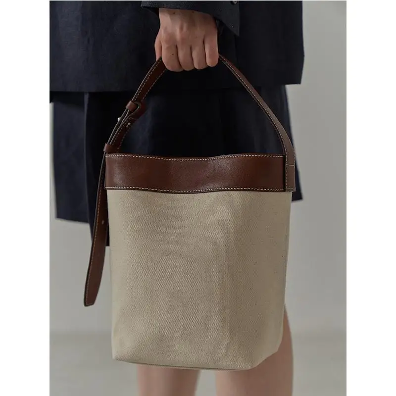 

2021 New Women's Cool Simple Splicing Contrast Color Portable Canvas Bag Versatile Commuter Leisure Versatile Bucket Handbag