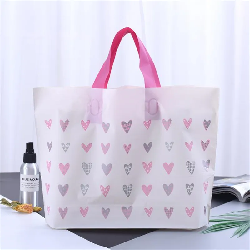 

Белый пластиковый пакет с ручкой, розовый Подарочный пакет, сумки для покупок для одежды, большой упаковочный пакет с множеством сердец, 50 ш...