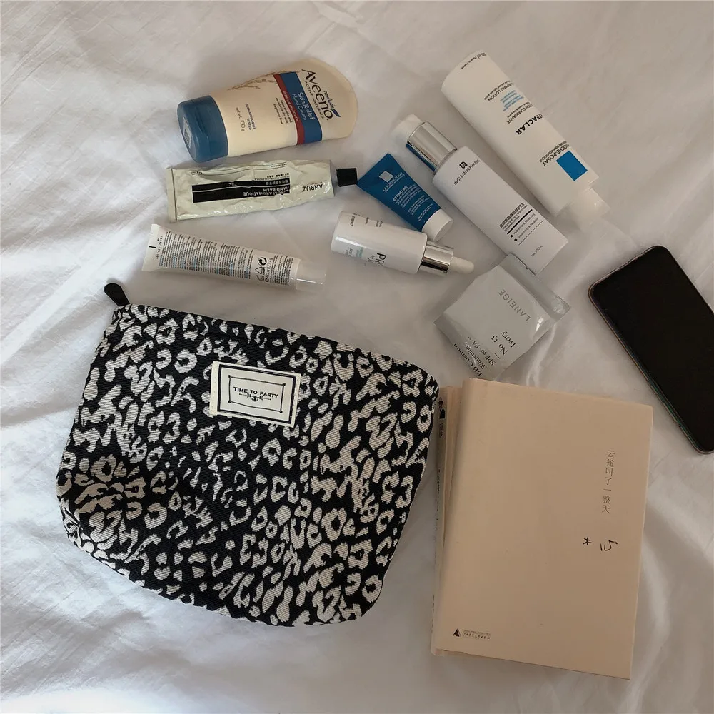 

Black and white cow leopard pattern thousand bird lattice fashion handbag hand bag cosmetic bag cloth bag storage bag trend
