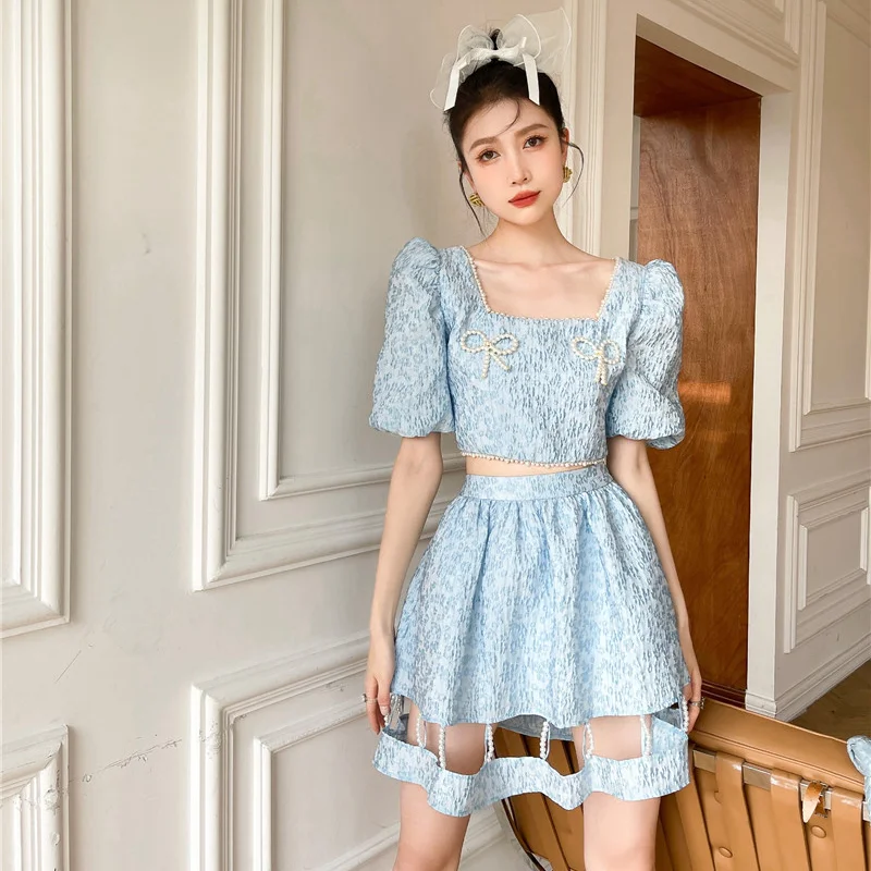 

Kimotimo Sweet Two Piece Set Women Relief Puff Sleeve Bow Pearl Cropped Top + Design Hollow Out Mini Pleated Skirt 2021 Summer