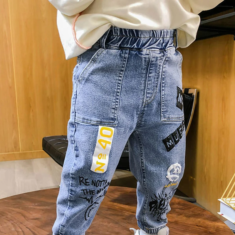 

Джинсы с принтом граффити для маленьких мальчиков и девочек, Осенние повседневные детские штаны, детские свободные брюки, милая одежда, 2021