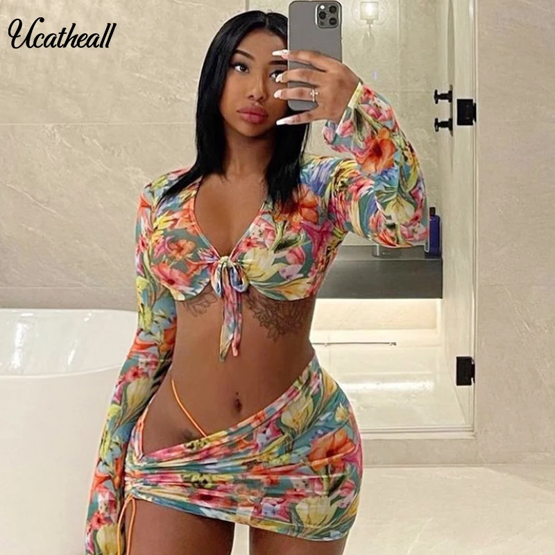 

2021 Summer Deep V Irregular Drawstring See Through Skirt Set Floral Print Dew Navel Blouse Mini Skirt Women Two Piece Set