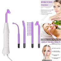 hand holding high frequency electrotherapy stick facial machine massager home beauty equipment home use spa tool