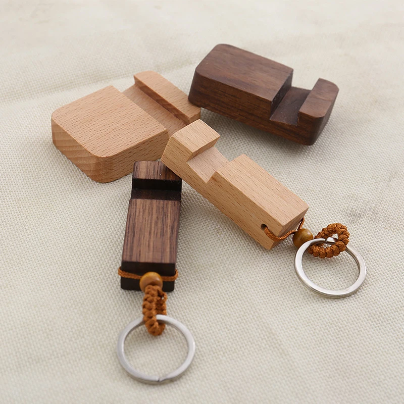 

Hot sale 1 Piece Of Fashion Creative Lightweight Slim Design Wooden Mobile Phone Stand Holder Stand Pendant Keychain 2021 New