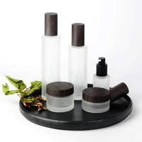dark wood grain cosmetic packaging 30ml 50ml 100ml 120ml frosted glass serum pump bottles with water transfer wooden lids