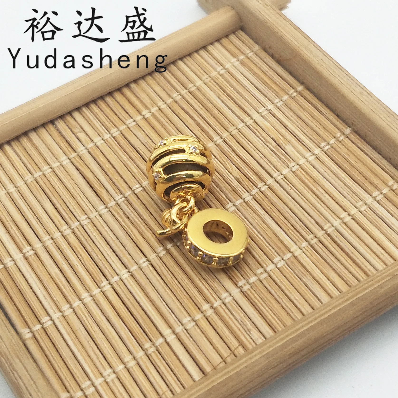 

Shining honeycomb pendant, a "buzzing" bee stopped on it. Sparkling cubic zirconia on the rings