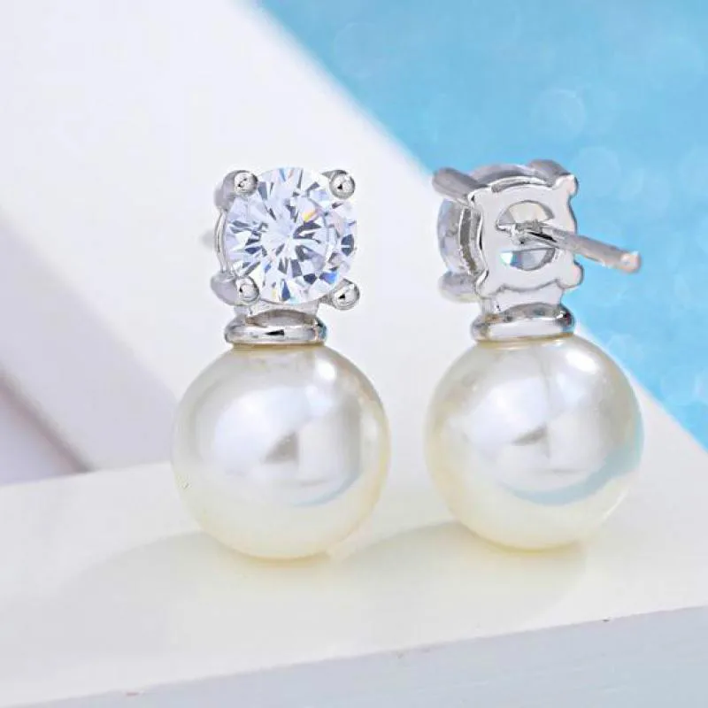 Серьги-гвоздики женские серебряного цвета с жемчугом и цирконом - купить по