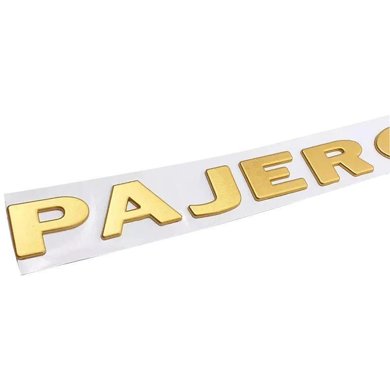 Золотой серебряный логотип PAJERO с надписью табличка названием Стайлинг