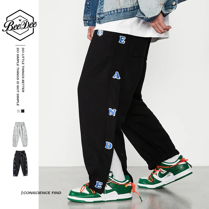 

2021 autumn new loose side men's design sense fashion slit sports pants nine points casual pants men's pants