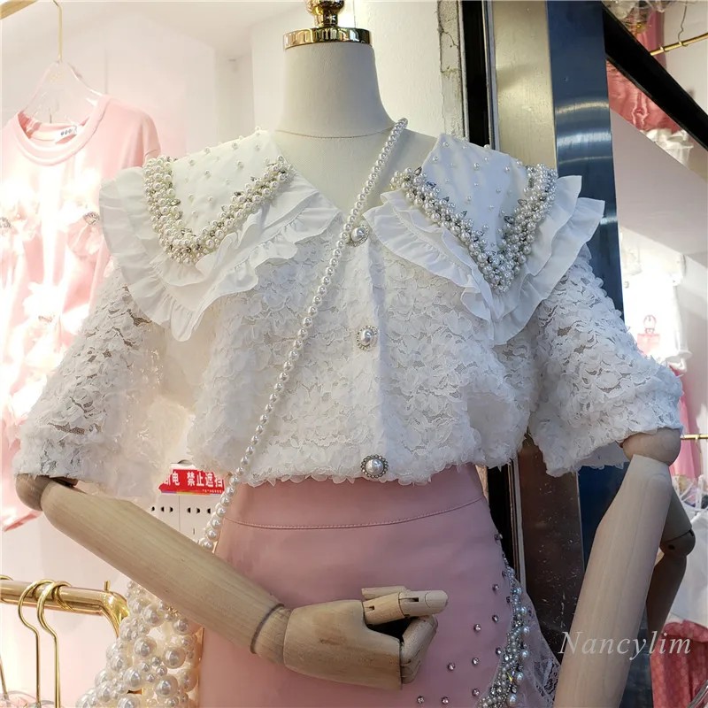 Chemise d'été en dentelle pour femmes, nouveau Style coréen, jolies perles, col de poupée, manches courtes bouffantes, Blouses assorties pour filles et dames, 2021