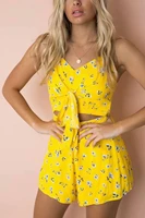 printed suspenders and bows tied with a bare waist romper